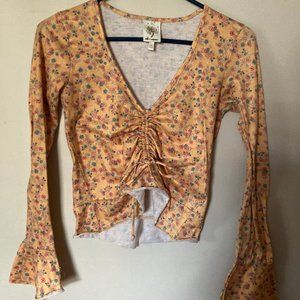 Cute orange floral cinched crop top with flare sleeves.